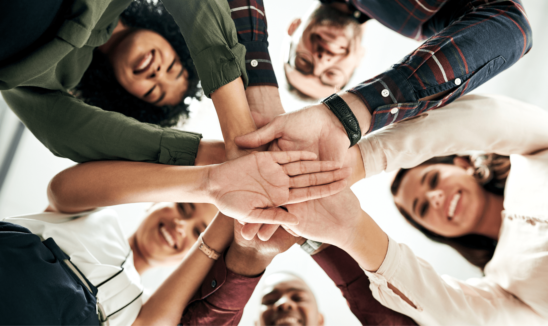Hands stacked together in a team huddle